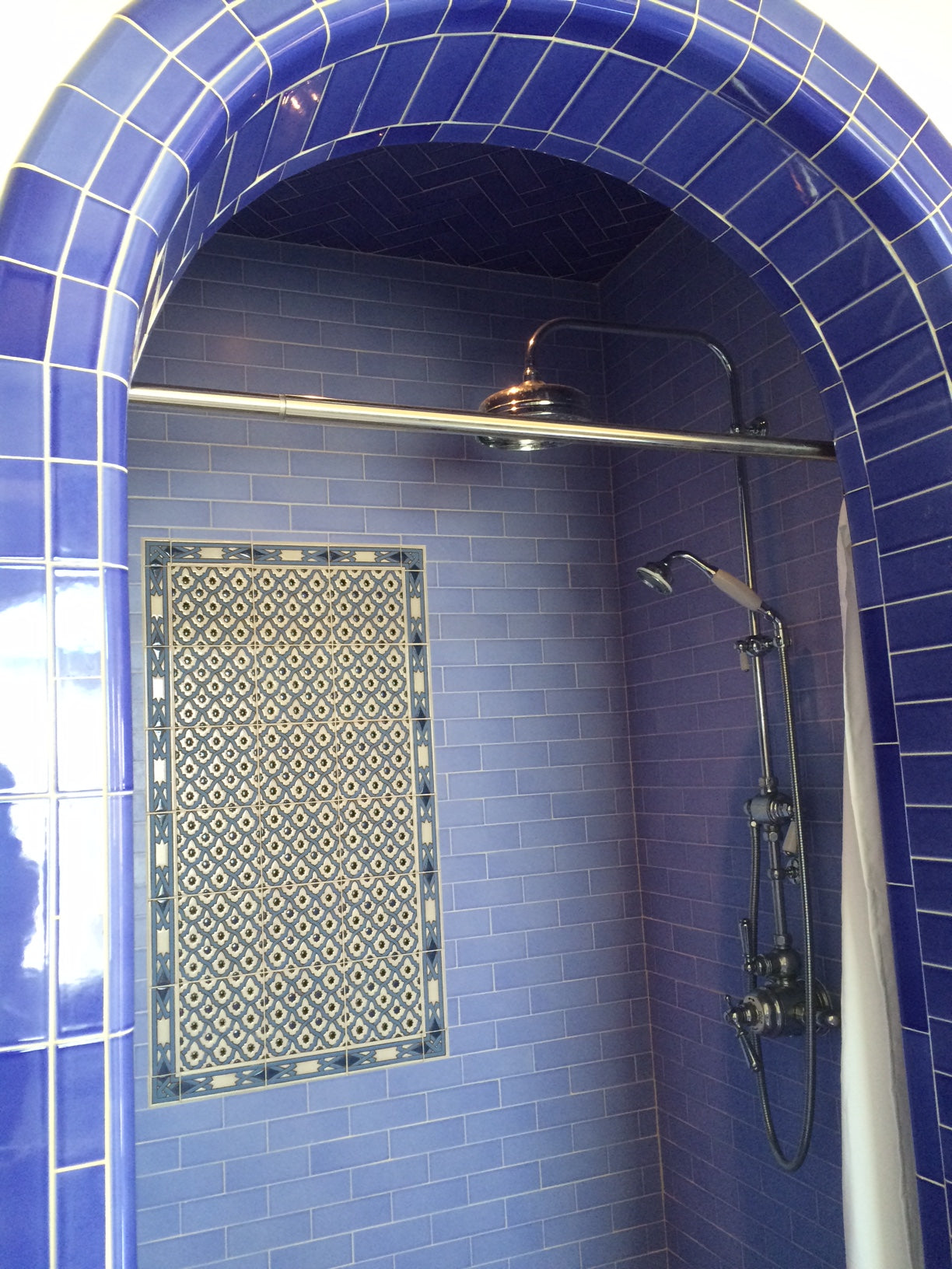 Hand-glazed blue field tiles with bathroom backsplash
