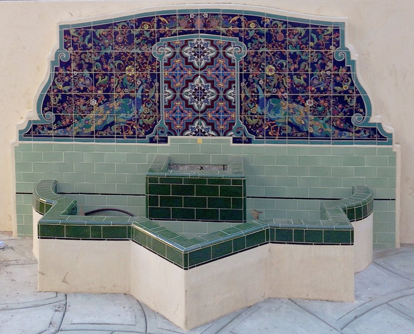 Adamsons house fountain  peacock mural in light blue, with green field tiles installed as  fountain